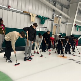 Un groupe d’élèves apprend à jouer au curling